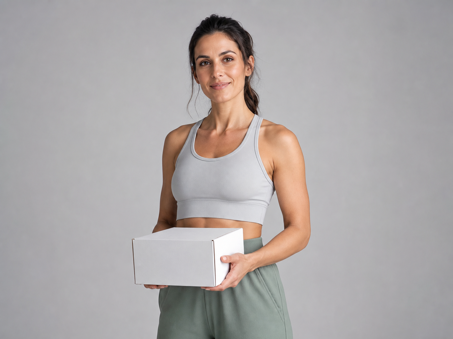 Aurelis customer holding a carefully packed delivery box in a clean studio